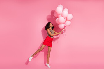 Full size photo of pretty young girl hold air balloons wear trendy leopard print outfit isolated on pink color background