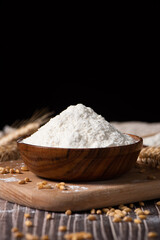 wheat flour and wheat ears on wooden table