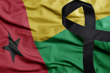 waving national flag of guinea bissau with black mourning ribbon .tragedy concept