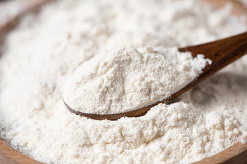 close up of white flour on wooden table