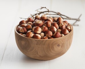 Hazelnuts in a wooden bowl isolated on white background