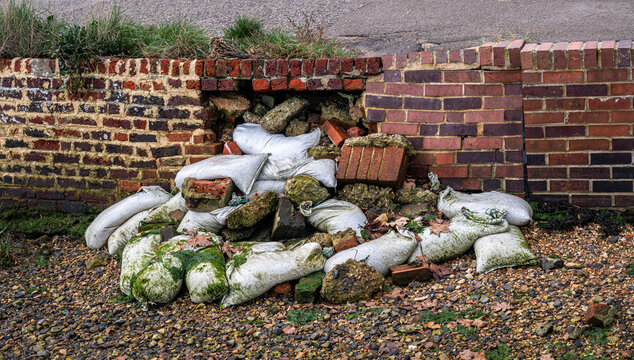 Erosion threatened coastal wall collapsed at Langstone harbour, Hampshire UK