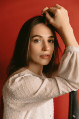 Close up portrait of cute woman wearing vintage style dress on red background