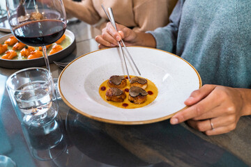 Luxury restaurant scallops truffle sauce gourmet dining experience elegant cuisine plate wine fine...