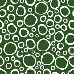 Circles seamless patten. Hand drawn white rings on green background. Abstract circle background.