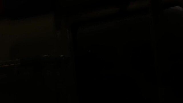 bright white lights of the tunnel are flashing outside the window at high speed.