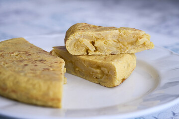 Small portions of Spanish omelette made with eggs, potato and onion on a plate. Typical tapas of...