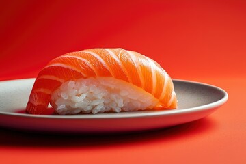 fresh salmon sushi on oval  plate on red background. healthy, gourmet Japanese dish. restaurant or fine dining concepts.