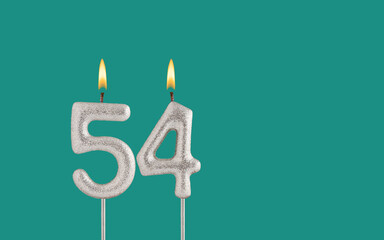 Birthday candle number 54 - Card on a green background.