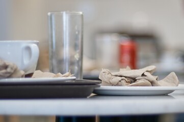 Abandoned cafe tables with used cups