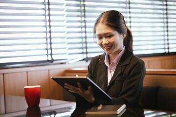 Asian businesswoman relaxing in a modern office