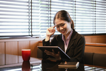 Asian businesswoman relaxing in a modern office