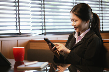 Asian businesswoman relaxing in a modern office