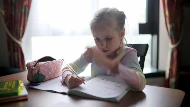 Schoolgirl doing her homework at home