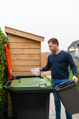 Man is sorting the plastic waste for the container at his house.