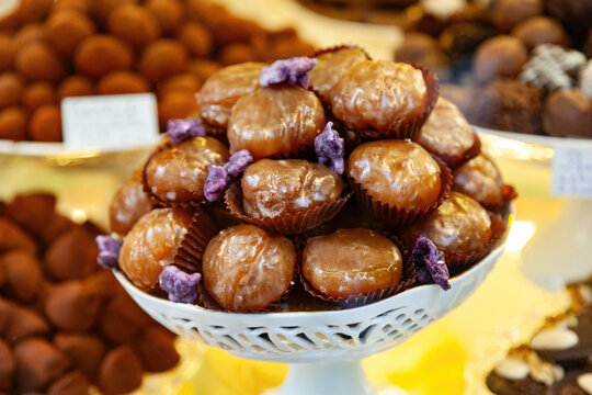 Glazed marrons glaces decorating a pastry shop window display