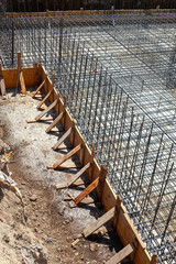 Foundation reinforcement steel bars and wooden formwork preparing for concrete pouring