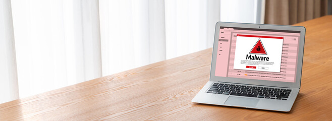 Cyber attacking concept. Malware alert showing on computer screen display scam and threat detection on computer system or online server to be removed snugly.