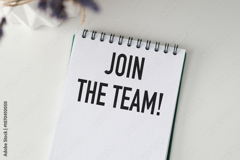 Poster a spiral bound notebook with the words join the team written on it