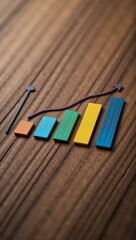 Fototapeta premium Colorful bar charts illustrate business performance on a wooden board showcasing steady growth