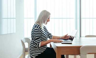 Mature businesswoman engaged in a virtual meeting using modern technology