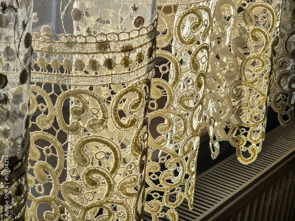 Poster intricate lace curtains softly filtering light, creating a delicate and elegant atmosphere in a room