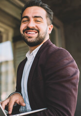 Portrait of cheerful bearded caucasian man in formal wear excited with completing work on online project using modern computer, happy  male millennial enjoying installing new software update on laptop