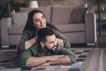 Photo of positive good mood man woman dressed khaki shirts enjoyig time together smiling indoors...
