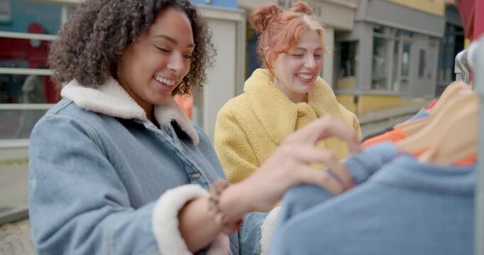Female Friends Shopping At Vintage Clothes Shop Market stall