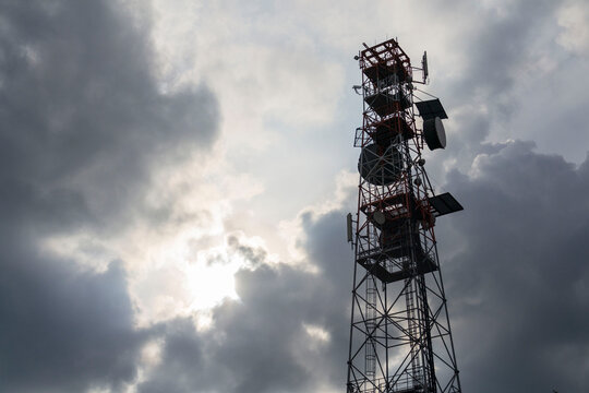Construction for broadband cellular network transmitters, telecommunication tower, new generation wireless communication concept, dramatic cloudy sky background with copy space