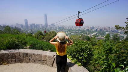 Visiting Santiago de Chile. Panoramic banner view of young traveler woman enjoying Santiago Skyline...