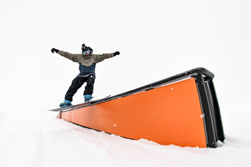 Snowboarder wallride mastery. Balancing act with impressive trick execution.