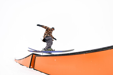 Wallride elegance. Skier demonstrates finesse in balancing and trick execution.