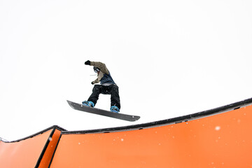 snowboarder bold jump into wallride showcases slope dominance.