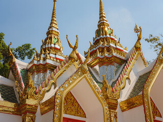 Fototapeta premium details of a small Modern Buddhist temple in Thailand, showcasing vibrant architecture and cultural heritage, with intricate details and spiritual atmosphere reflecting Thai tradition and design.