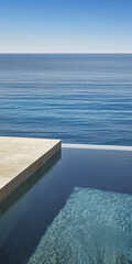 Fototapeta premium Serene infinity pool overlooking tranquil blue ocean on a sunny day near the coast