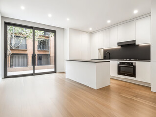 Modern kitchen interior with large windows and wooden flooring in a stylish urban apartment