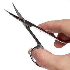 Scissors, nail clippers in hand. Photograph on a light background.