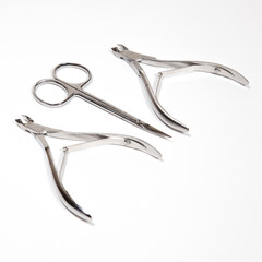 Scissors, nail clippers. Photograph on a light background.