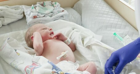 Neonatal Care Cherishing Every Moment Spent in the Hospital with Your Newborn Baby. A dedicated healthcare professional is actively tending to a newborn in a warm and caring hospital setting