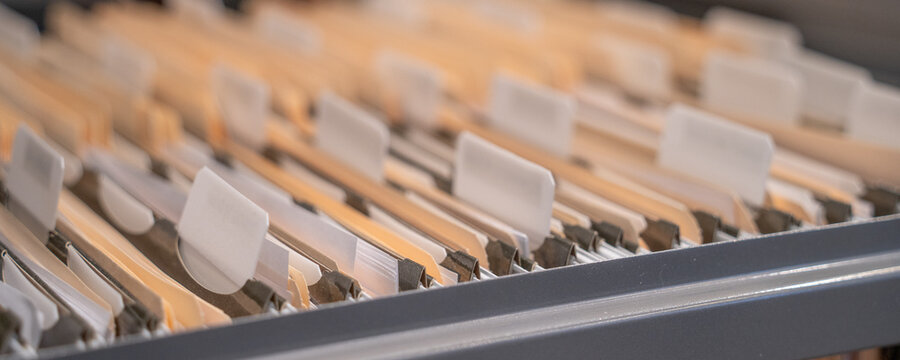 Hanging files in filling cabinet in an office