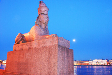 Egyptian sphinx made of granite stone against the sunset, sculpture.