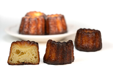 Caneles de bordeaux, traditional French sweet dessert with white table background, High quality photo