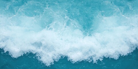 Fototapeta premium A close-up view of turquoise ocean waves crashing, creating a foamy white texture, evoking serenity and the beauty of marine nature.