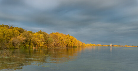 A cloudy sky with a lake in the background