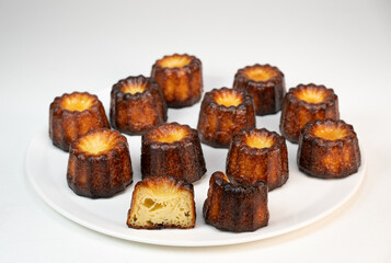 Caneles de bordeaux, traditional French sweet dessert with white table background, High quality photo