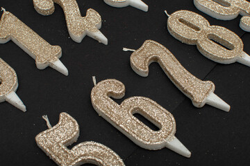 Birthday numeral candles on black background