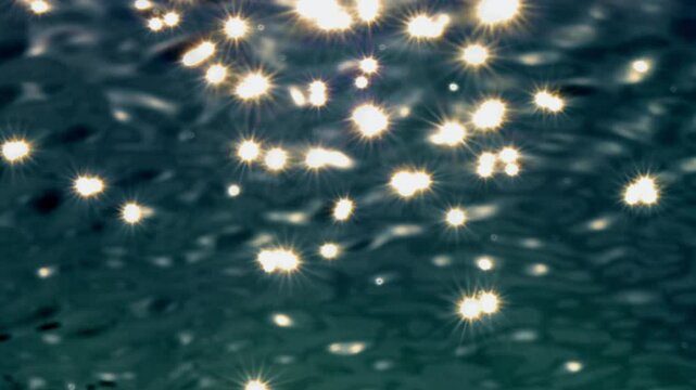 sparkling sunlight stars over rippled water surface texture, nature background decoration template concept for beauty spa, travel and vacation, top view slow motion