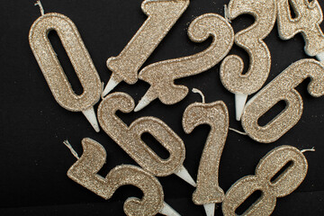 Birthday numeral candles on black background