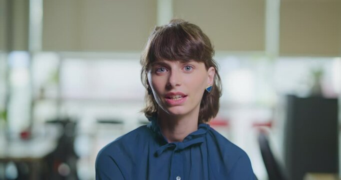 Happy young adult gen z woman lady intern look web cam do distant work casual talk client on video call office. Head shot girl female worker expert tutor speak ideas share plan teach study job place